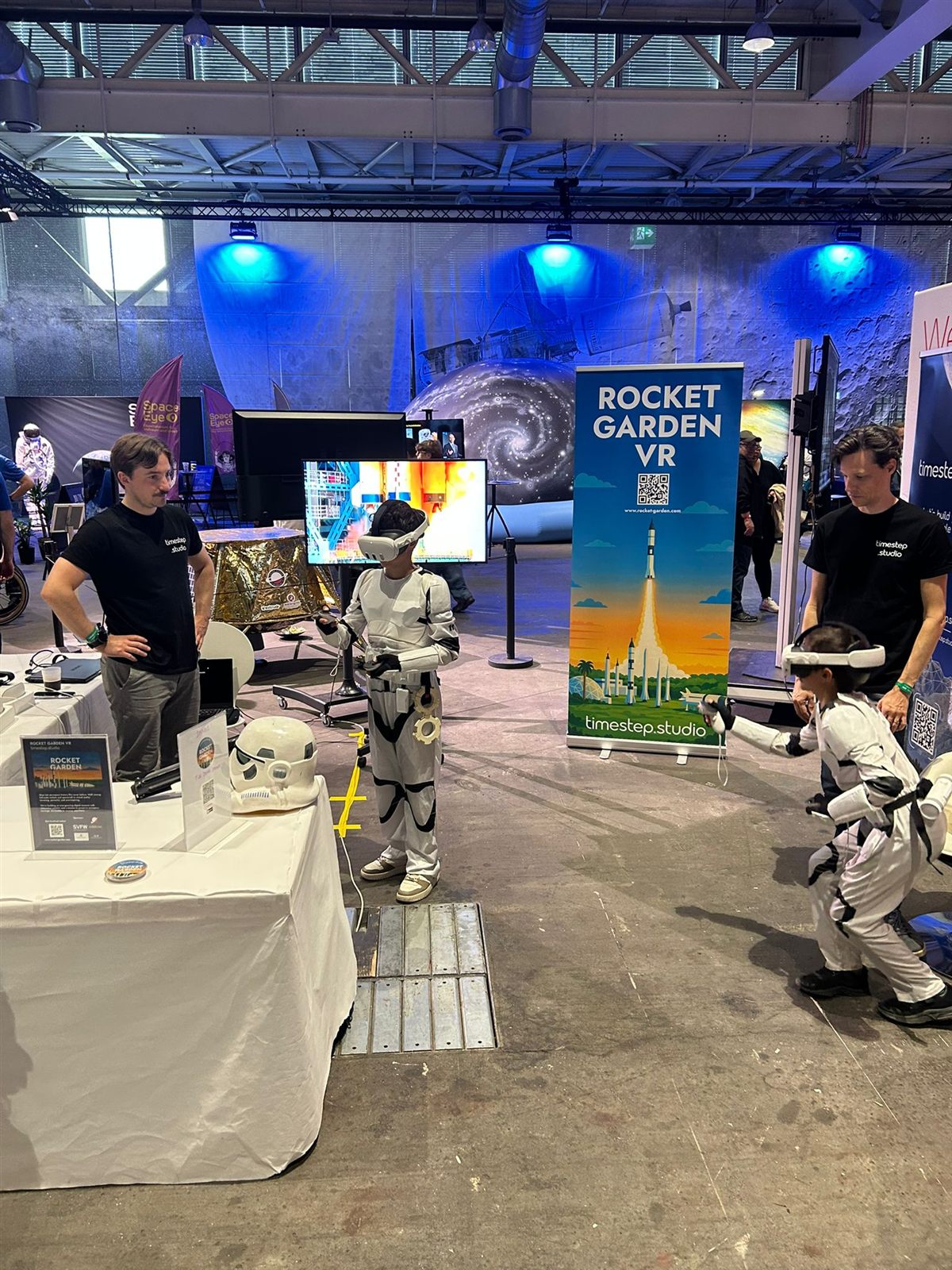 Children in stormtrooper costumes playing Rocket Garden in VR at the Timestep Studio stand.